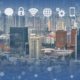 City skyline with digital cloud icons overlaying buildings, representing the integration of cloud infrastructure services in urban environments for seamless connectivity, data security, and digital transformation